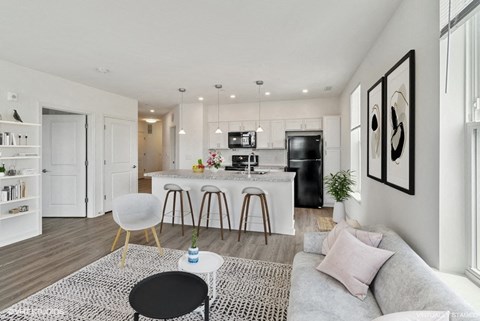 a living area with a kitchen and a couch and a table