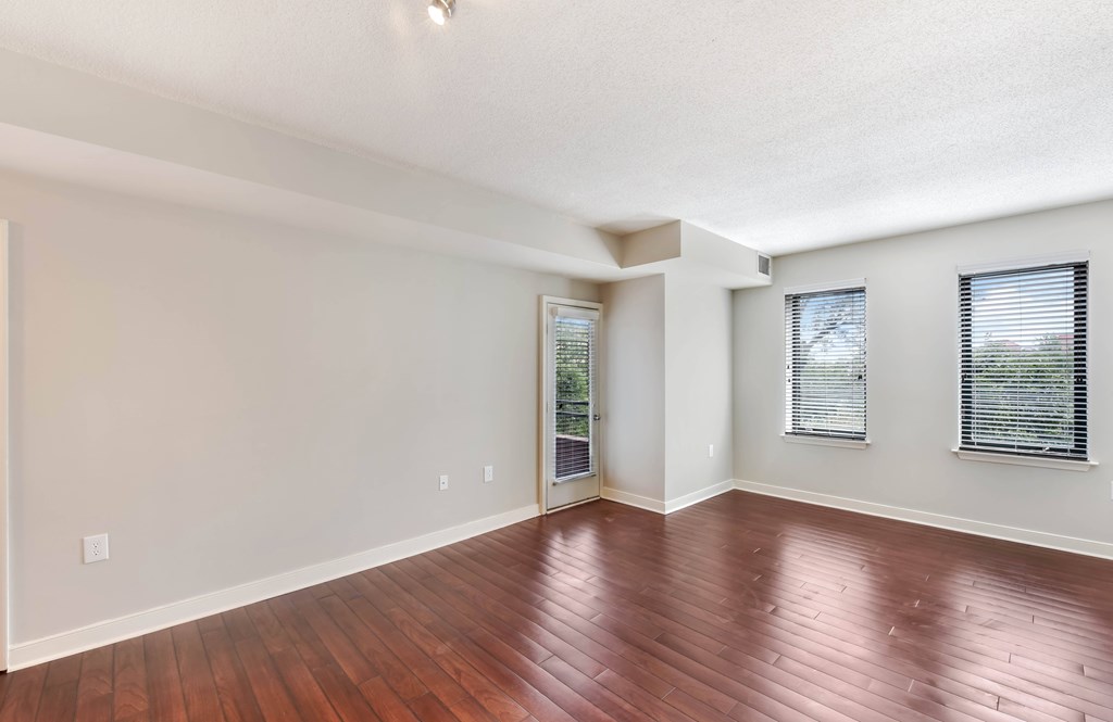A room with wooden floors and white walls.