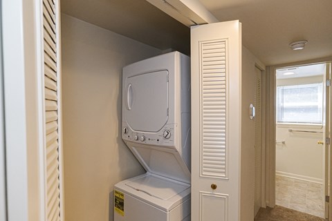 an empty laundry room with a washer and dryer