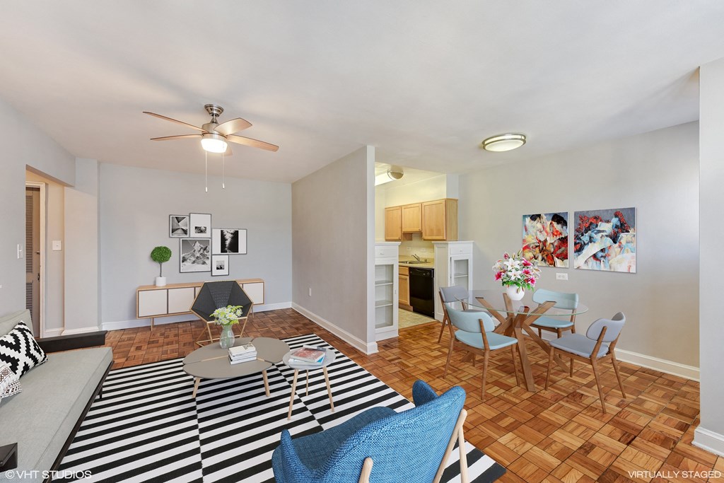 a living room with a couch and a table and a dining room with chairs at The Chesapeake, Washington, DC 20008