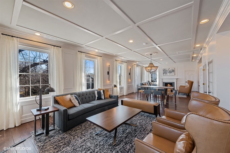 a living room with couches and chairs and a table