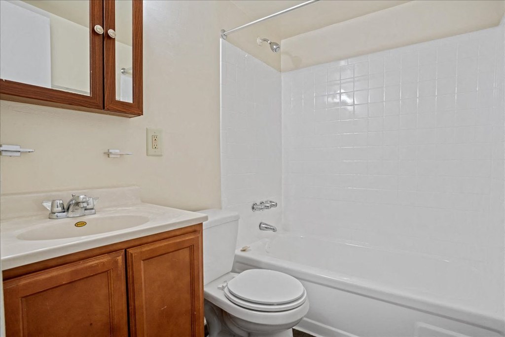 a bathroom with a sink toilet and bath tub