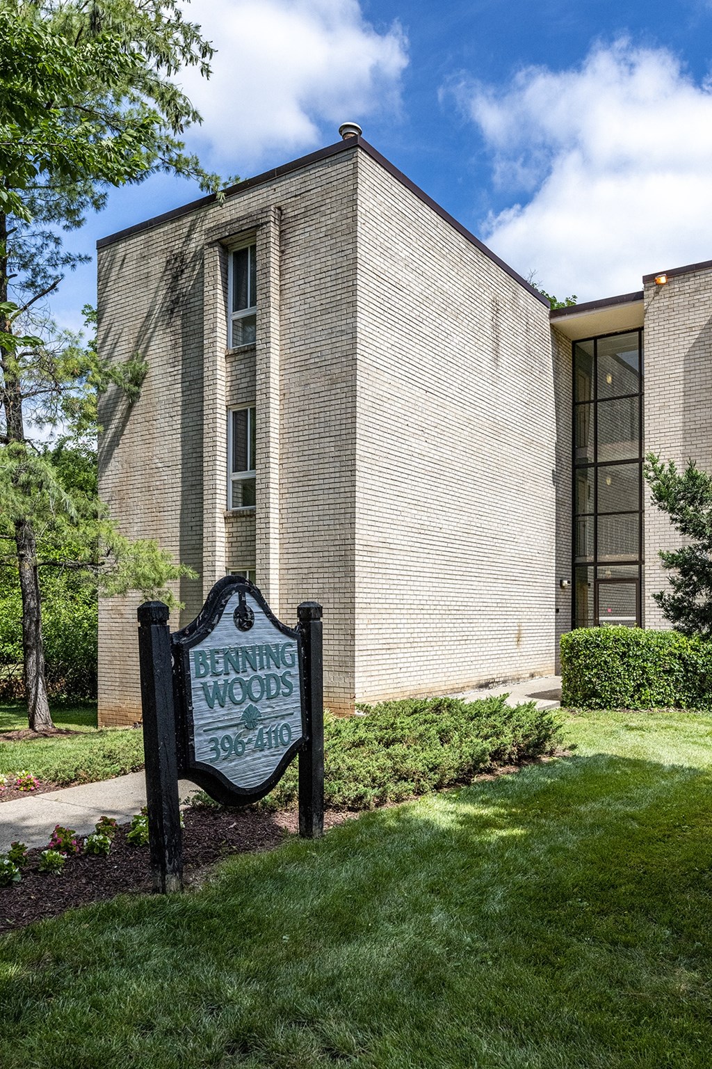 Benning Woods building with property name sign in front of it