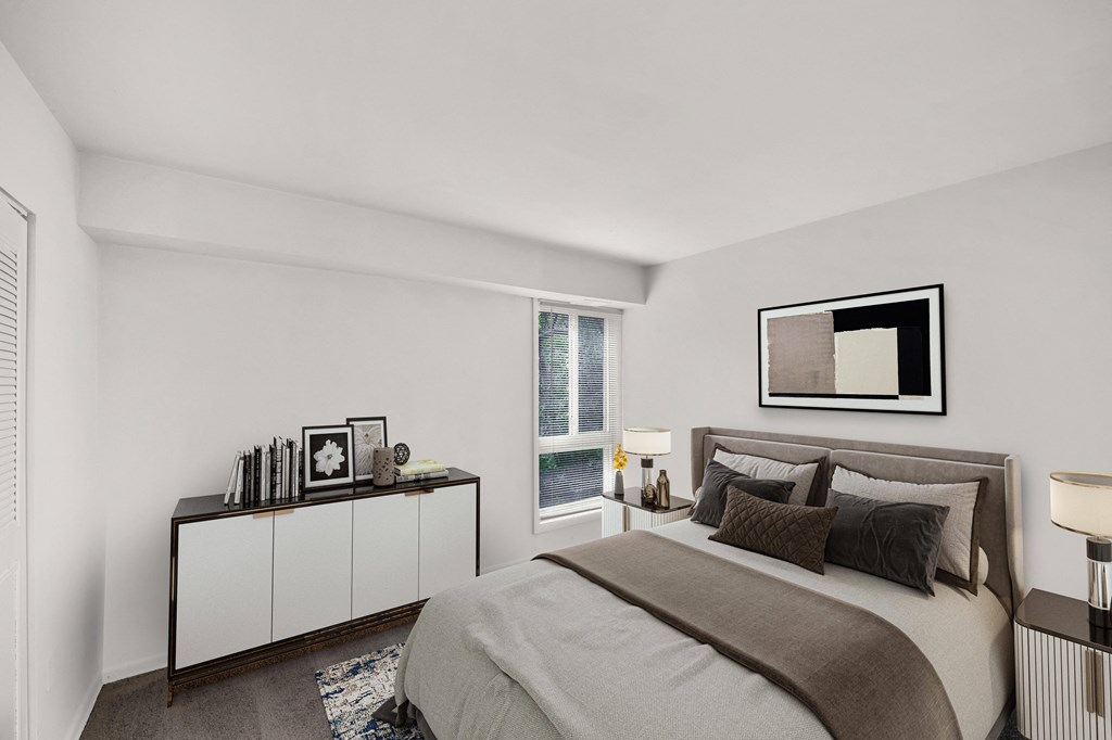 a bedroom with a bed and a large window