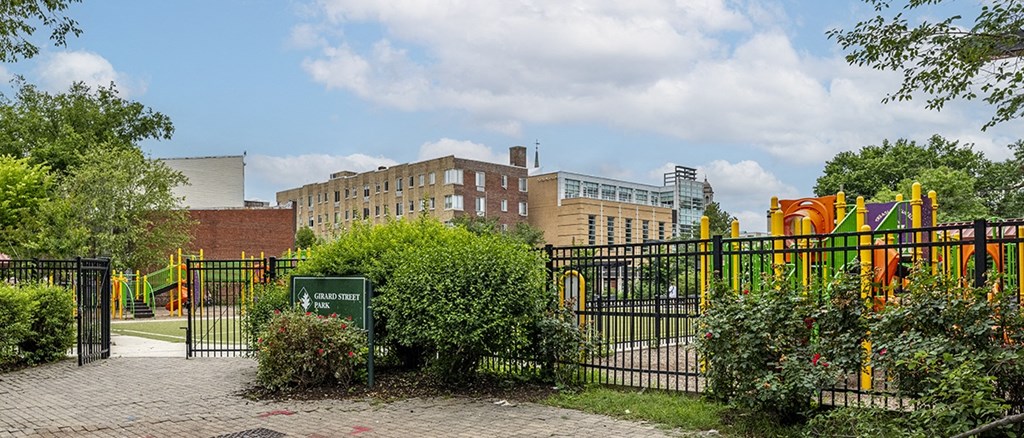 a park with a playground and buildings in the background
