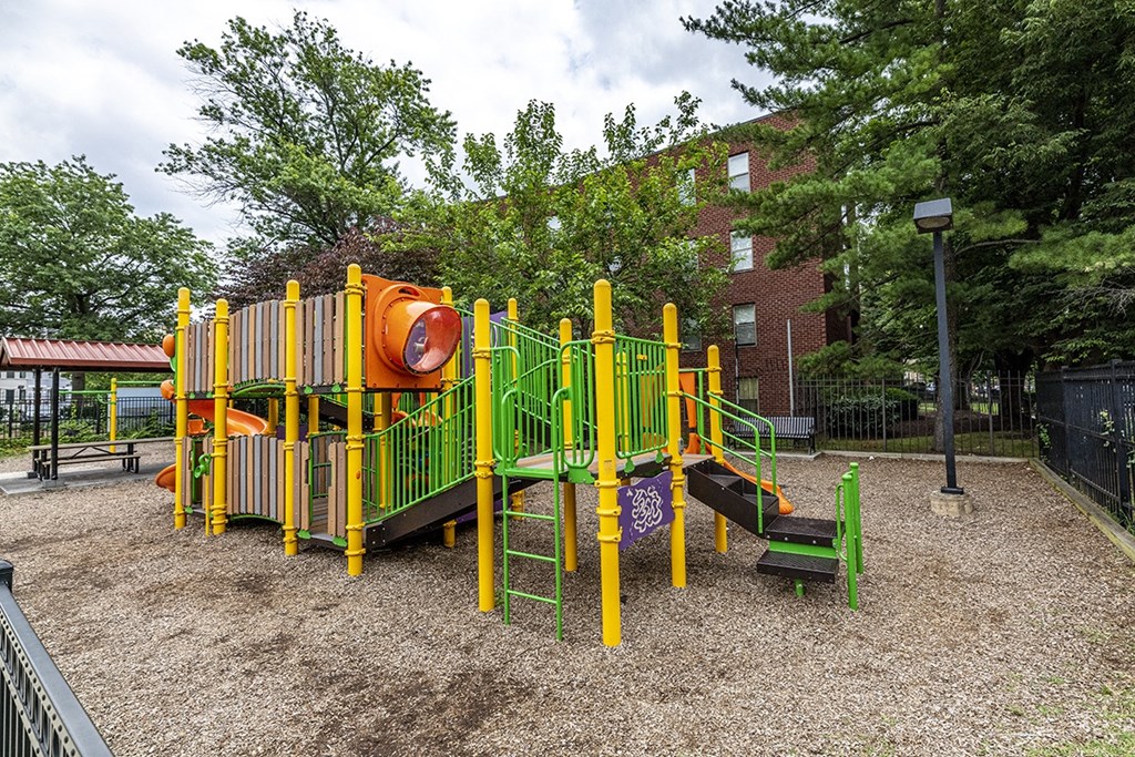 a playground in a park in front of a building