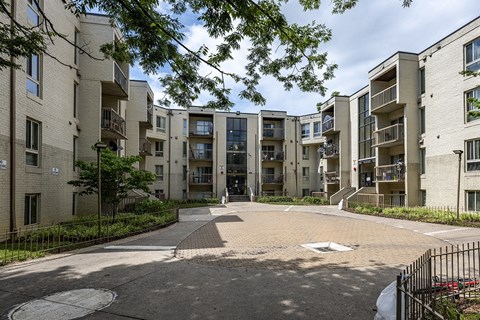 an empty parking lot between two apartment buildings