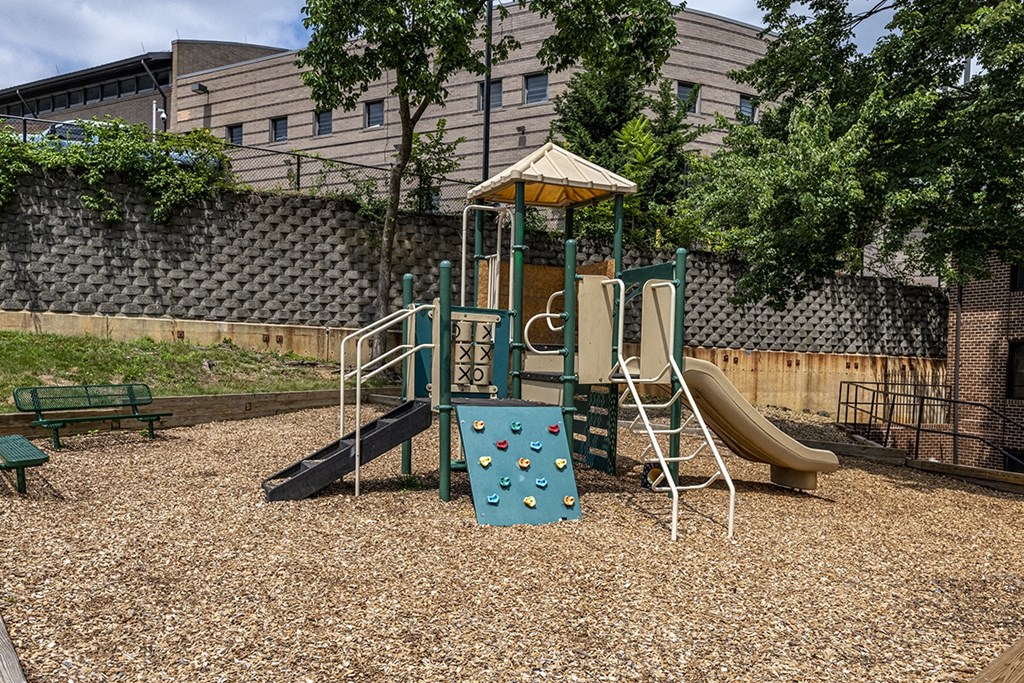 a playground with a swing set and slides
