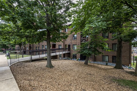 a brick building with trees in front of it