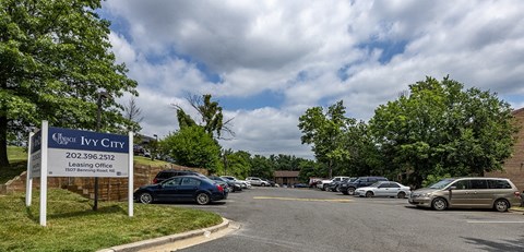 a parking lot with cars parked in front of a city gym sign