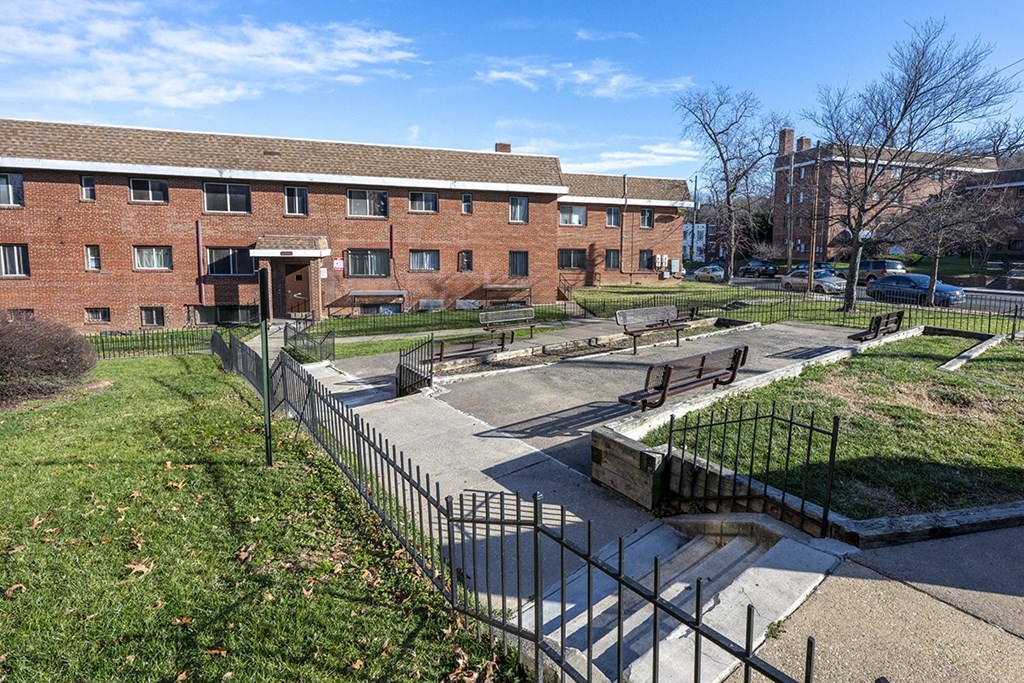 a park in front of a brick building