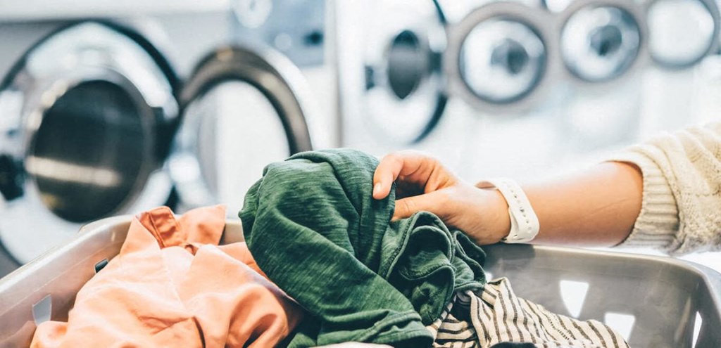 a woman washing clothes in a laundry room