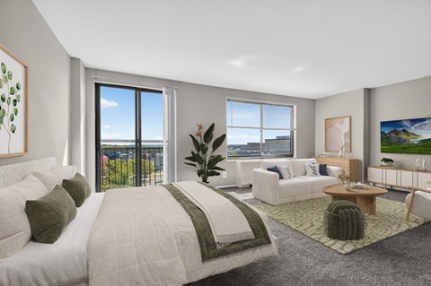 A bedroom with a large bed and a view of the city.