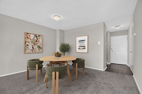 A dining room with a round table and chairs.