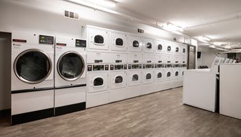 A row of washing machines in a laundromat.