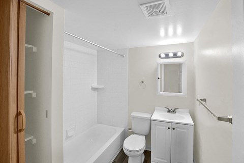 a bathroom with a sink toilet and a tub