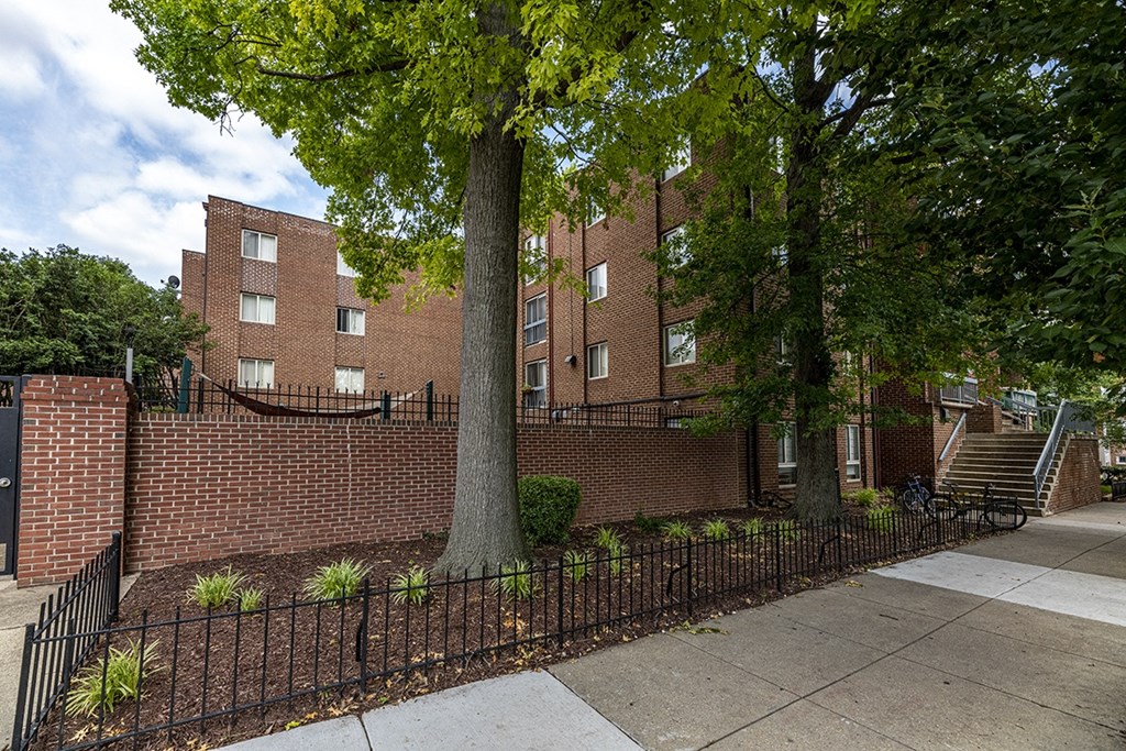 a large brick building with a tree in front of it