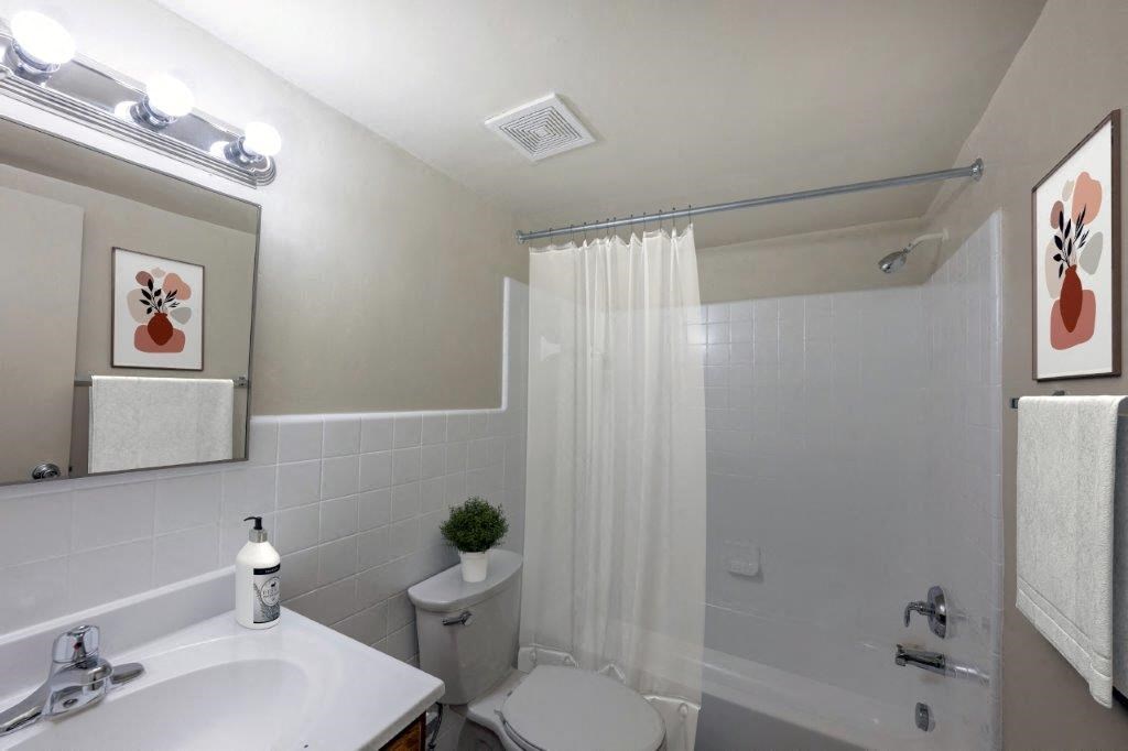 a bathroom with a toilet and a sink and a shower