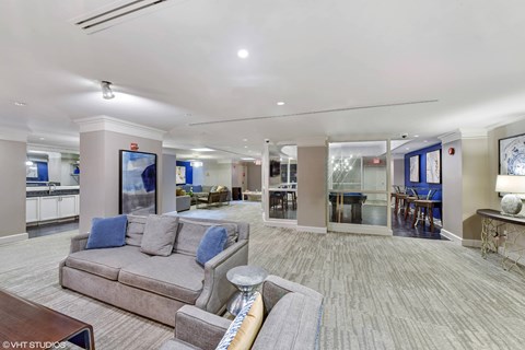 A spacious living room with a grey couch and a coffee table.