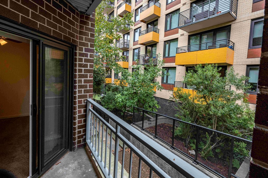 a balcony with a view of an apartment building