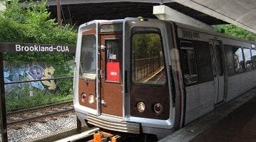 a train that is sitting on the tracks at Brookland Ridge Apartments, Washington DC
