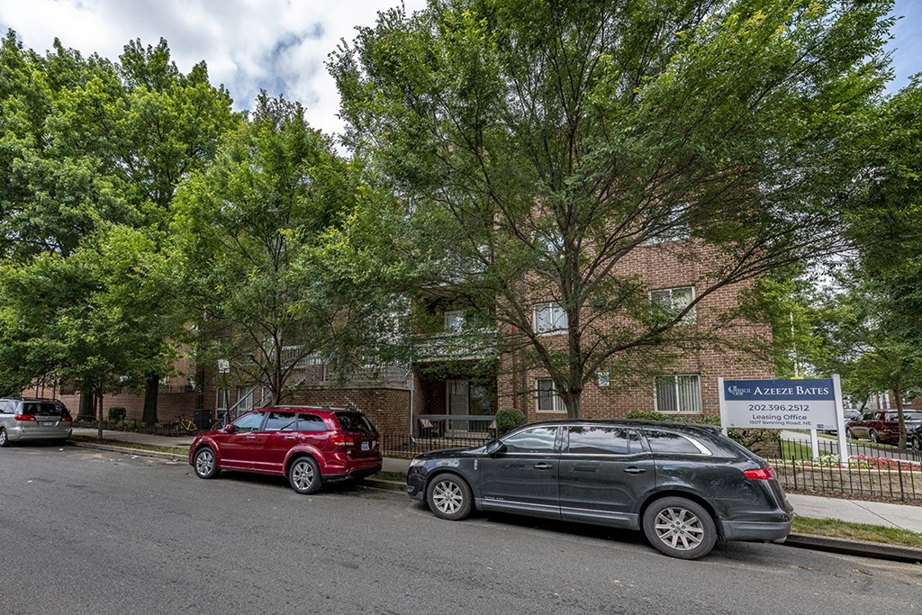 a brick building with cars parked in front of it