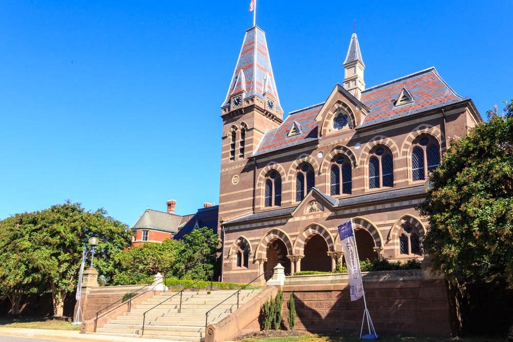 a large brick building with a steeple and a clock tower