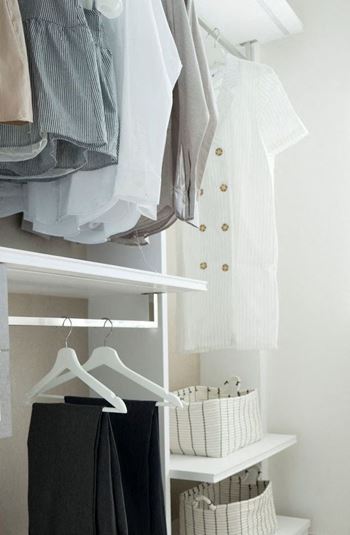 a closet filled with clothes and a rack of clothes