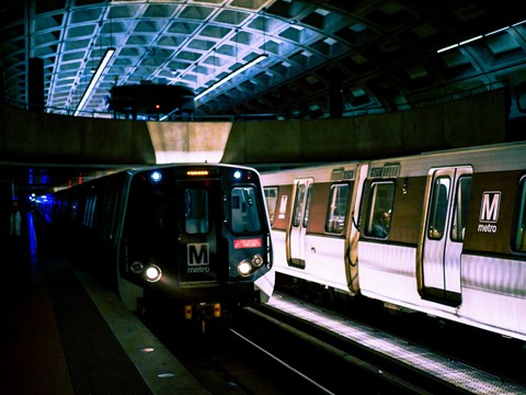 a subway train pulling into a subway station at night