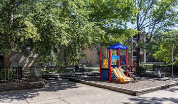 a playground with a swing set and a slide