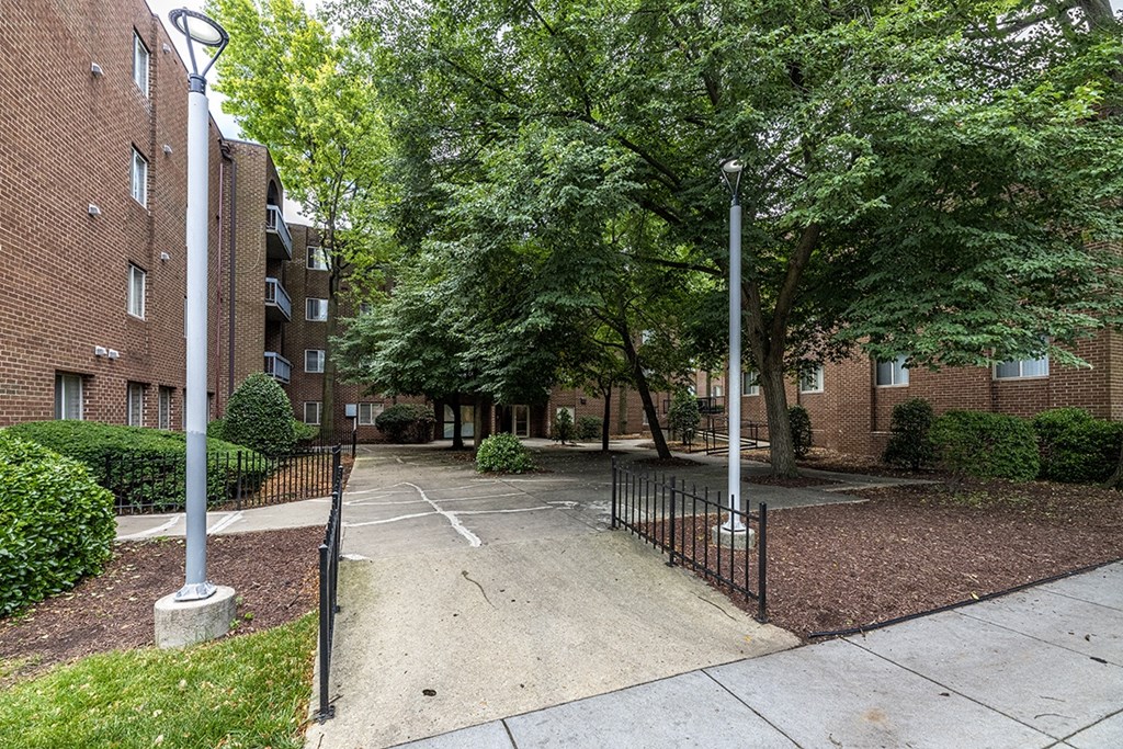 an empty parking lot in front of a brick building