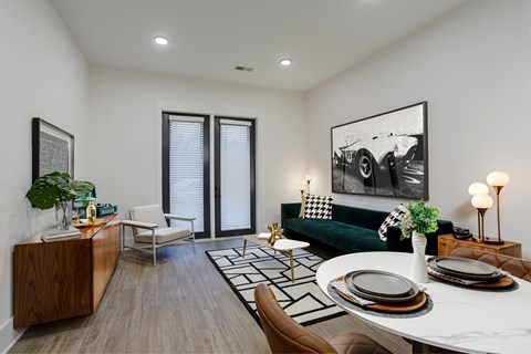 A modern living room with a green couch and a coffee table.