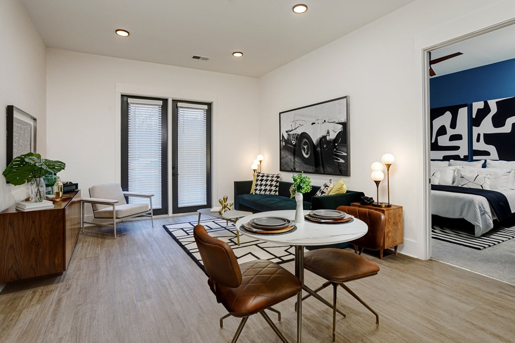 A modern living room with a dining table and chairs at Vintage Edge Nashville Apartments, Nashville, Tennessee