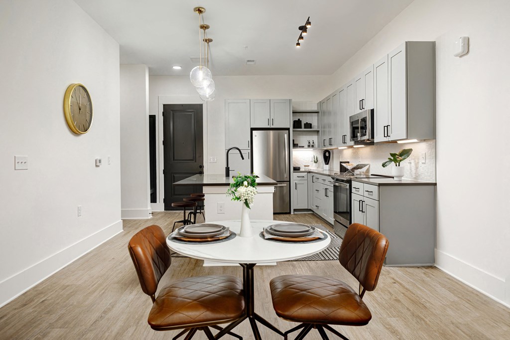 A modern kitchen with a dining table set for two. A modern kitchen with a dining table set for two at Vintage Edge Nashville Apartments, Tennessee, 37211