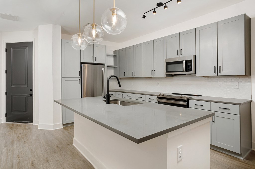 A kitchen with a large island and modern appliances at Vintage Edge Nashville Apartments, Nashville, TN, 37211