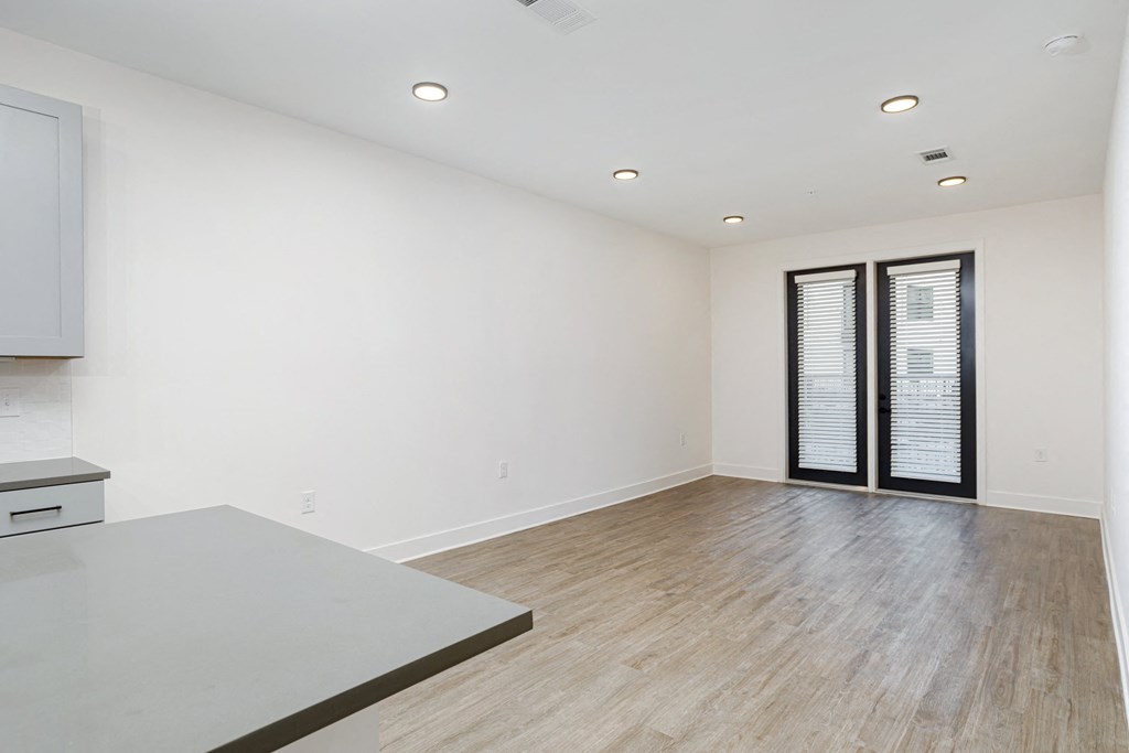 A room with a grey table and wooden floor at Vintage Edge Nashville Apartments, Nashville, TN