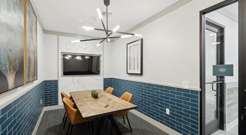 A dining room with a wooden table and chairs at Vintage Raleigh West Apartments, Raleigh