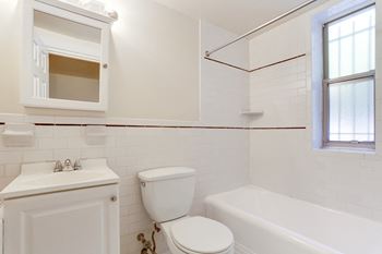bathroom with white tile and tub at Tivoli Gardens, Washington, DC, 20010