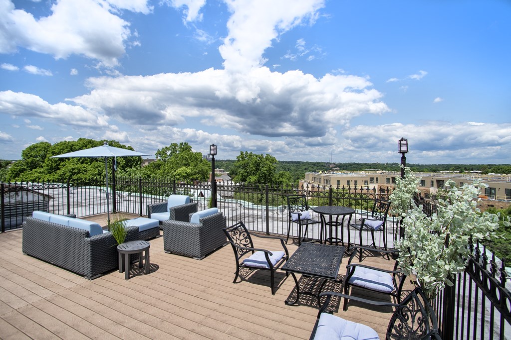 a rooftop patio with tables and chairs and a view of the city at Park Terrace, Washington