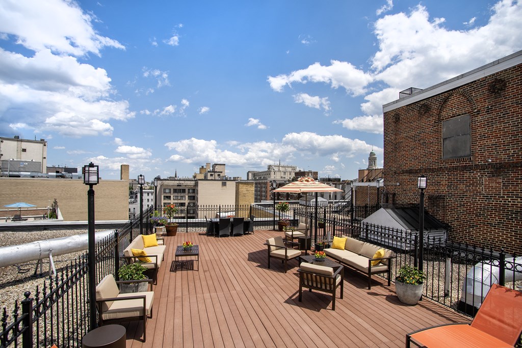 a roof deck with furniture and a view of the city