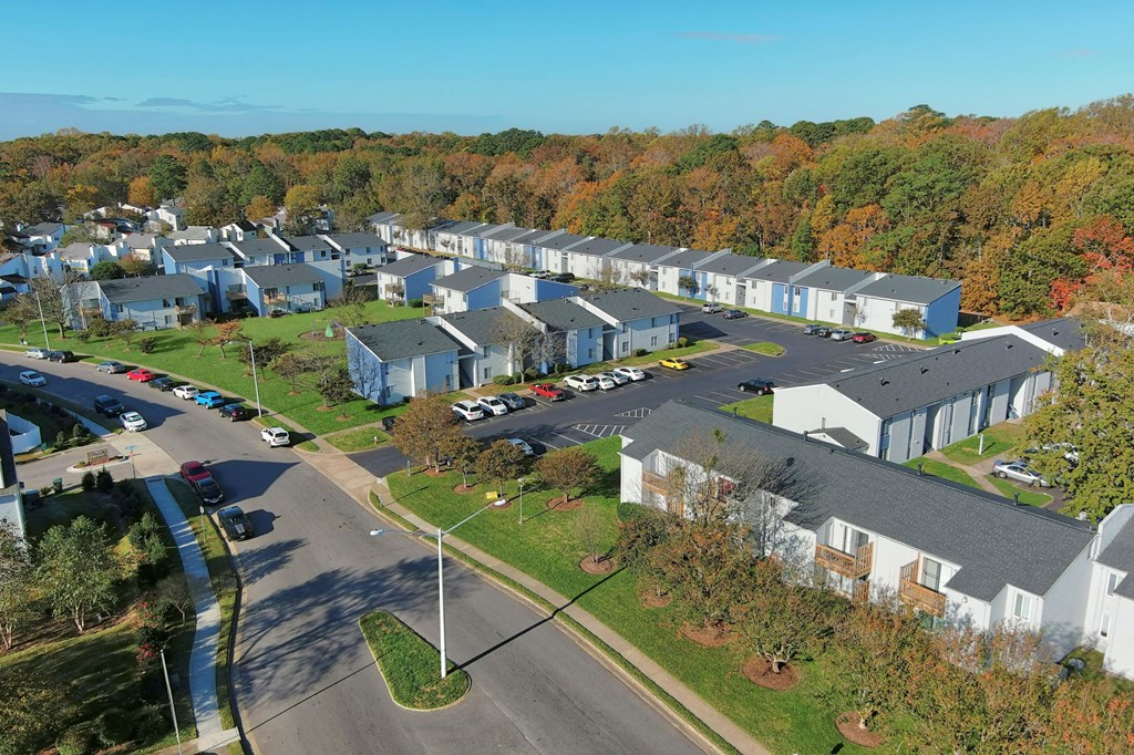an aerial view of a group of houses in a parking lot
