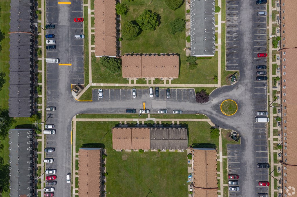 A parking lot with cars and a yellow circle on the pavement.