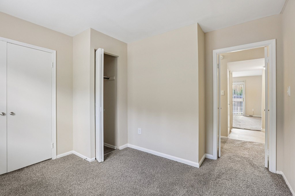 A room with a carpeted floor and white walls.