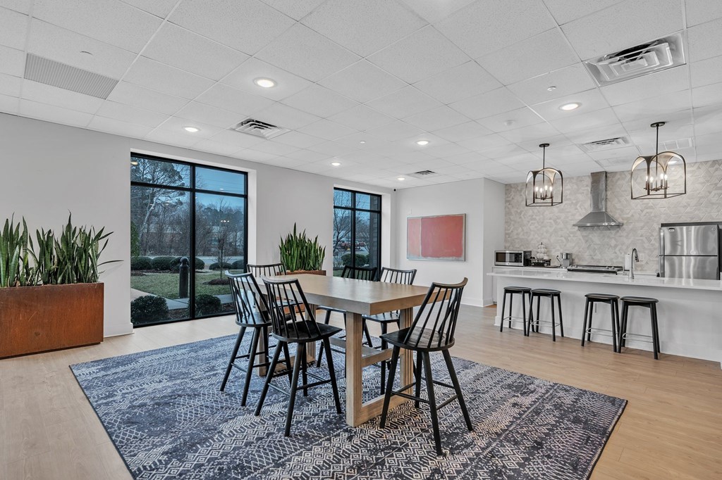 A dining room with a table set for four.