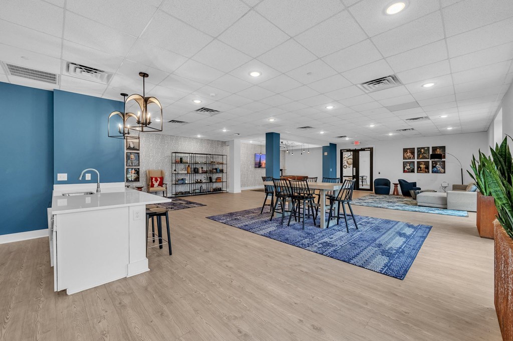 A kitchen with a white island and blue walls.