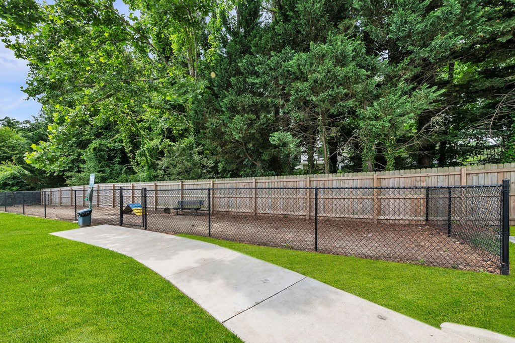 A park with a fence and a bench.