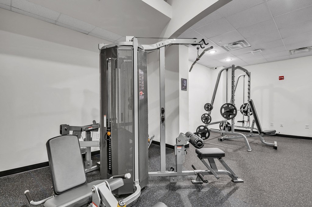 A gym with a variety of equipment including a leg press machine.