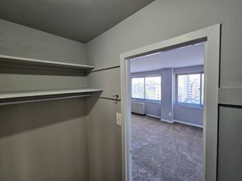 an open kitchen with a granite counter top and a living room at The James On Merrimac, Williamsburg, VA