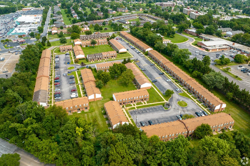 An aerial view of a large building complex surrounded by trees.