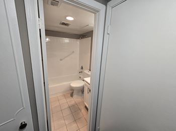 a laundry room with a washer and dryer and a kitchen with a refrigerator at The James On Merrimac, Williamsburg, 23185